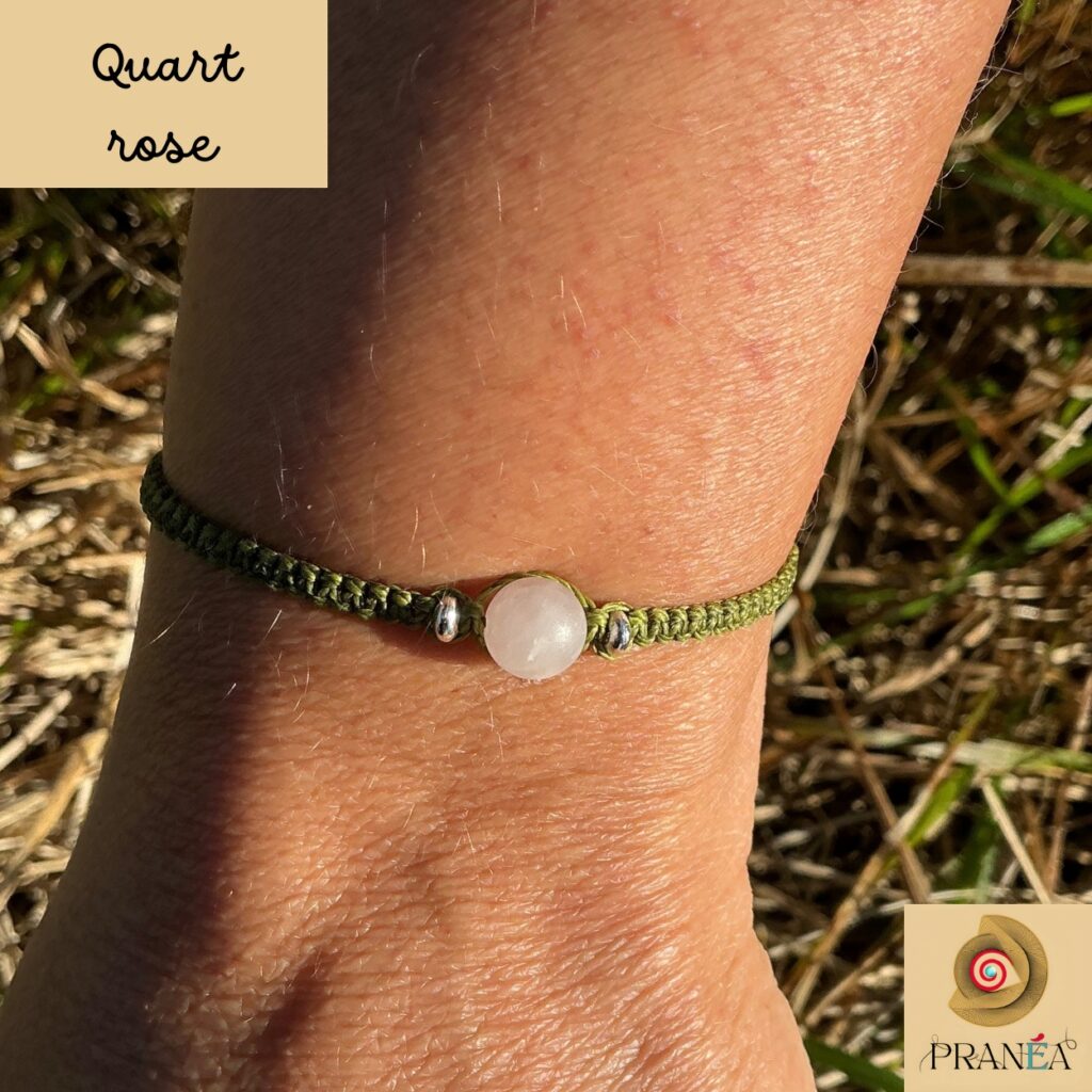 Bracelet en quartz rose porté au poignet, fil vert en macramé, diffuse amour et paix intérieure.
